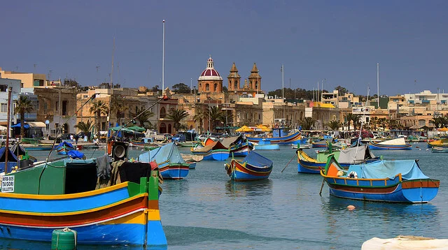 Traditional painted luzzu fishing boats in Marsaxlokk harbour